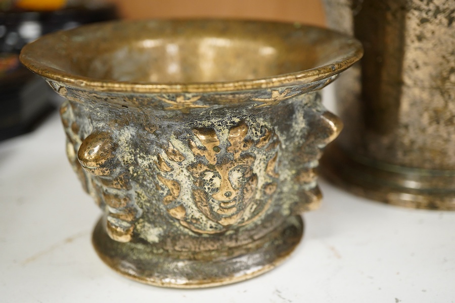A bronze pestle and mortar, and one other mortar decorated in relief, 18cm in length